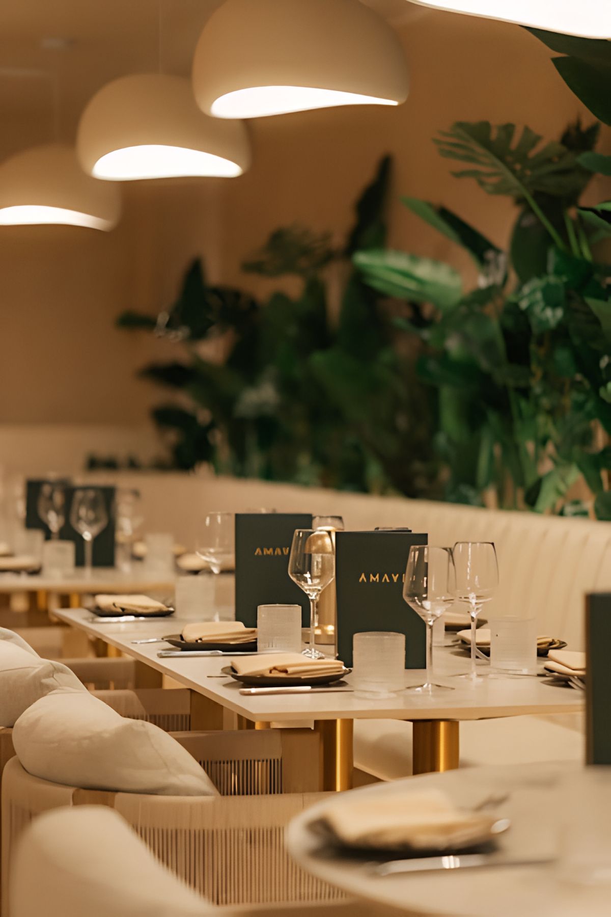 cream banquette with gold-leg tables and place settings