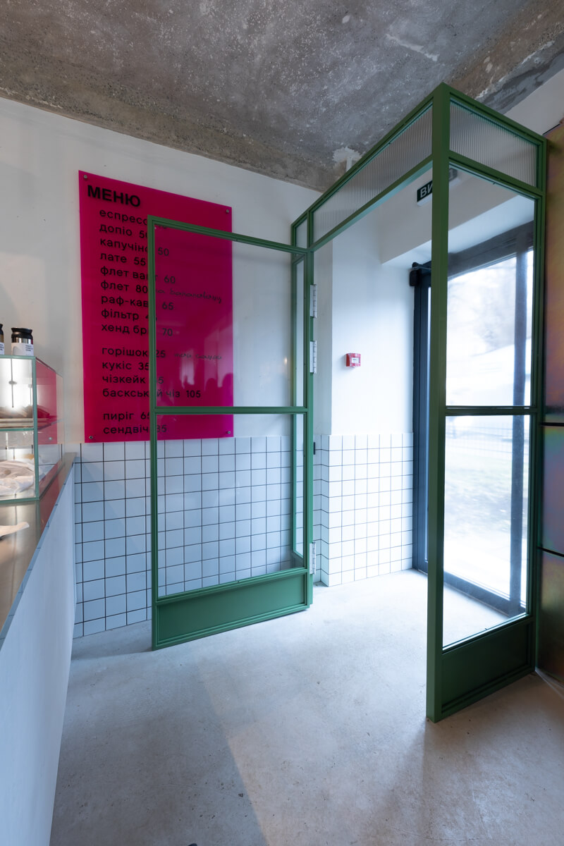 entry vestibule with green steel partition and ukrainian menu board