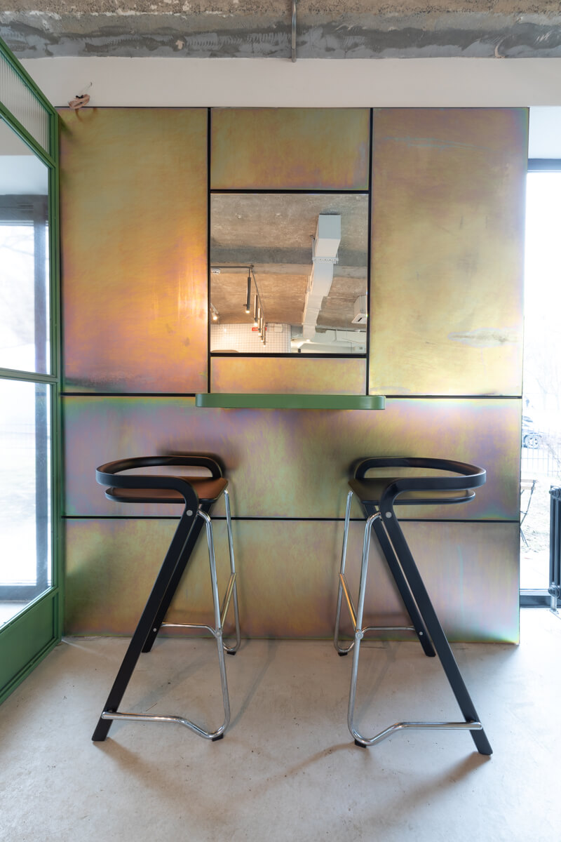 iridescent oxidised steel wall cladding with bar stools