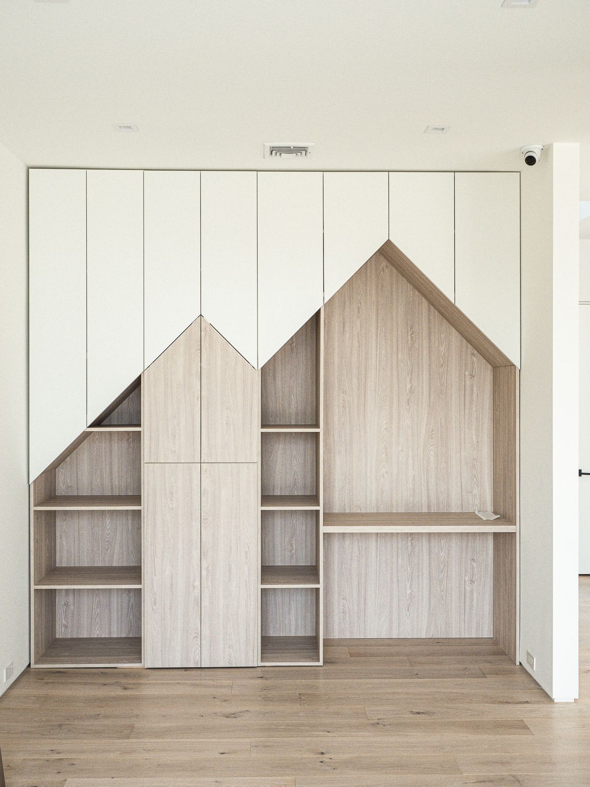 house-gable cabinetry with open shelves and desk alcove