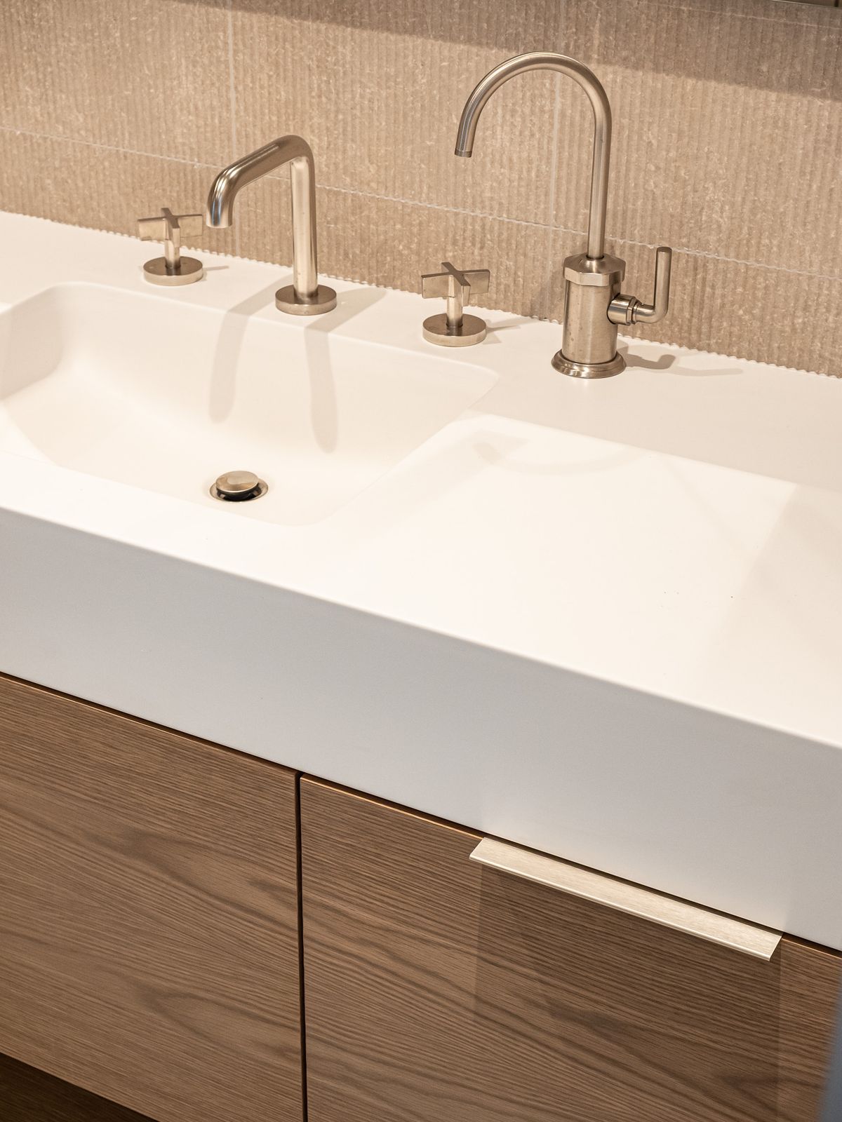 white integrated sink with dual brushed metal faucets