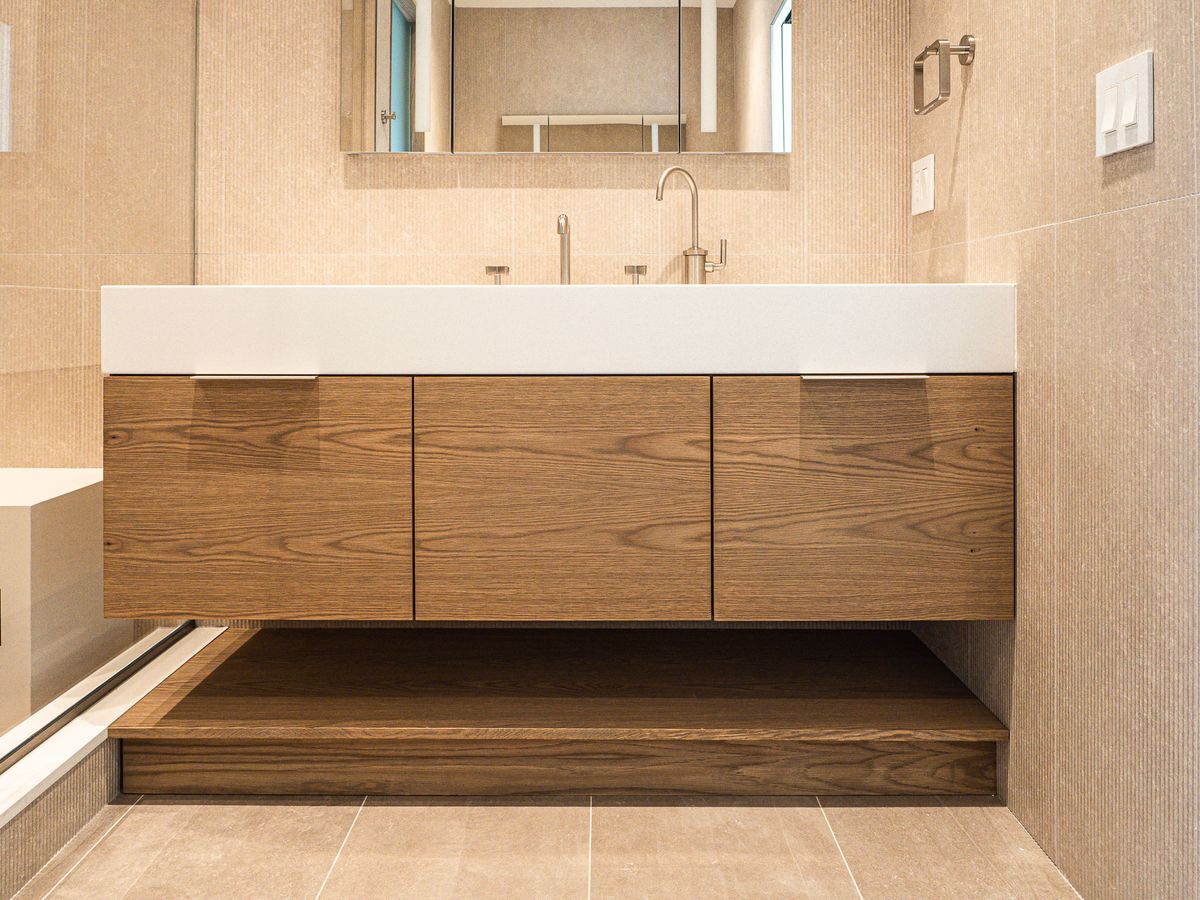 floating three-door vanity with dual deck faucets