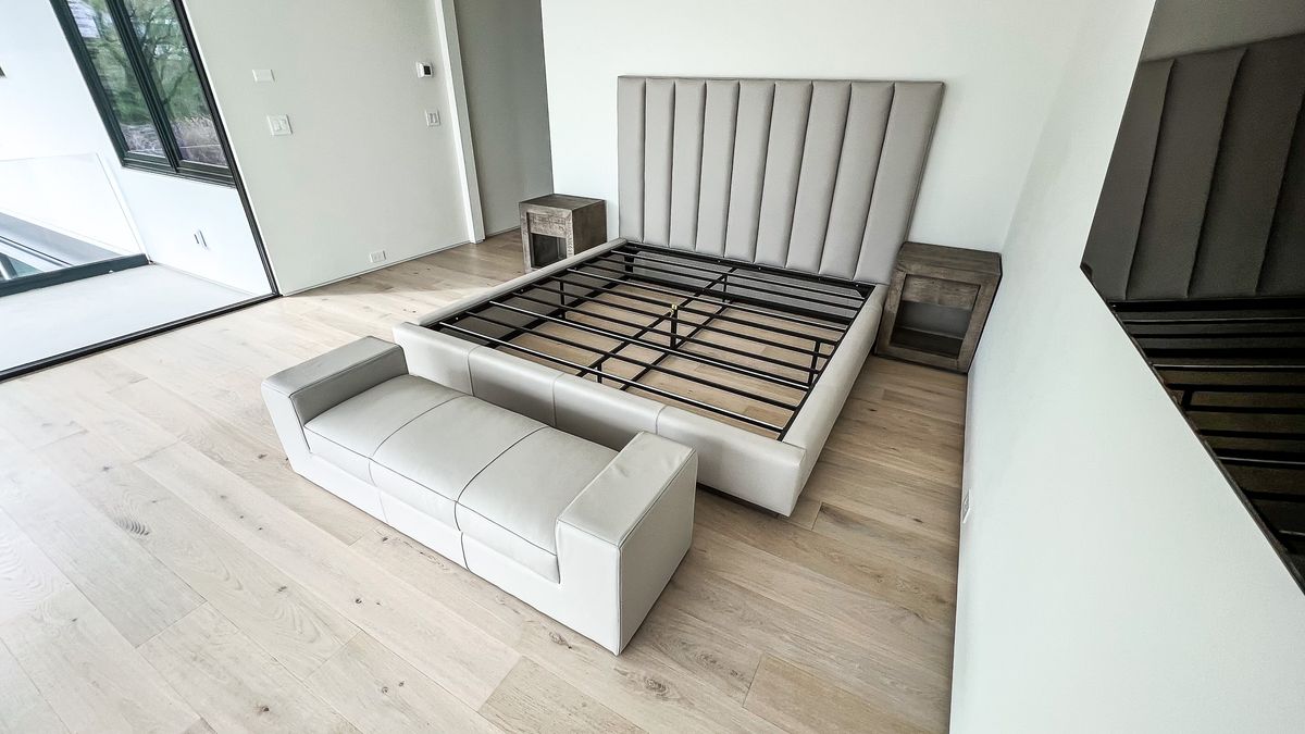 gray upholstered bed frame with bench and nightstands
