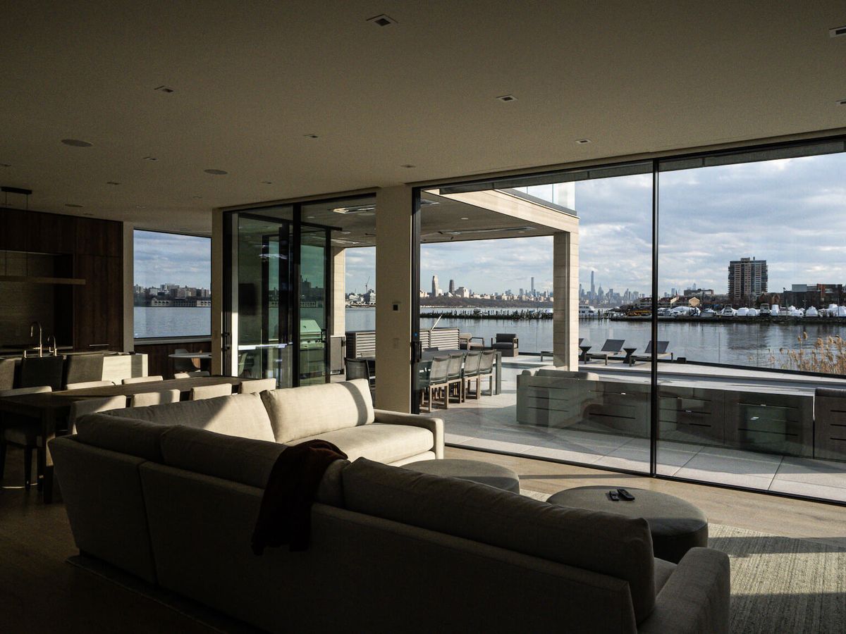 living room opening to waterfront terrace and skyline