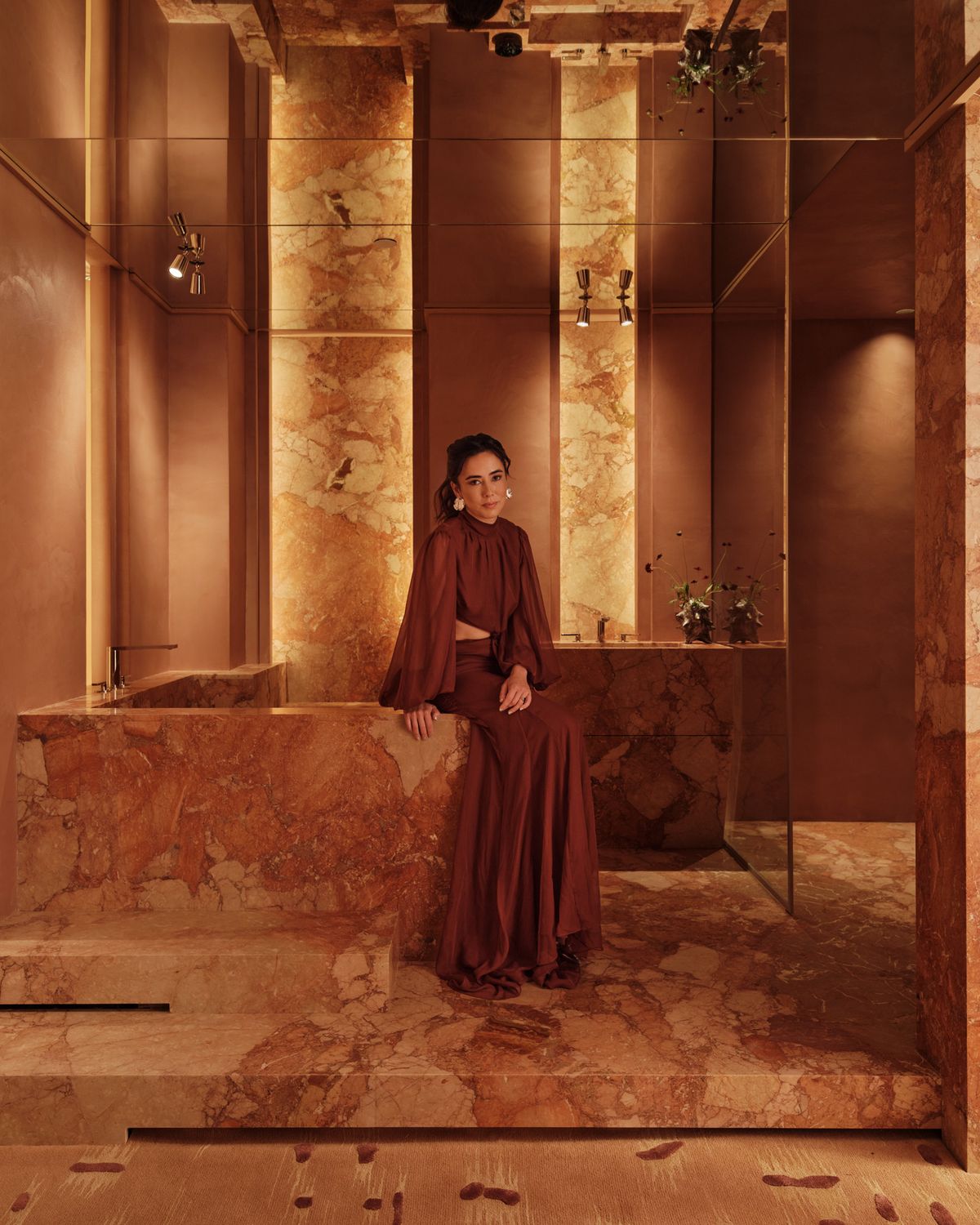 megan grehl in the finished bath, beside the stone tub