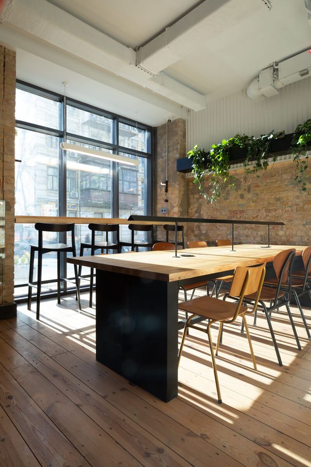communal table in morning light, detail of wood top and chairs