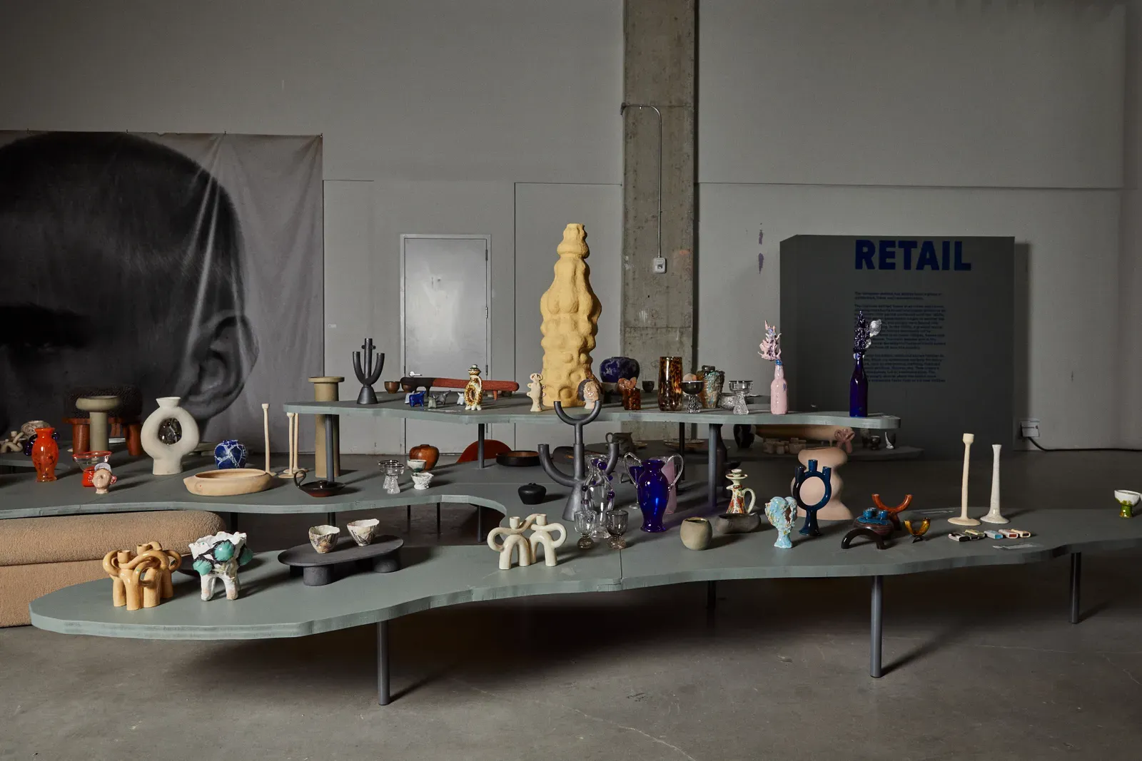 sculptures and glassware on tiered grey platforms