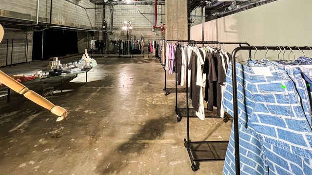 clothing racks and display table in warehouse space