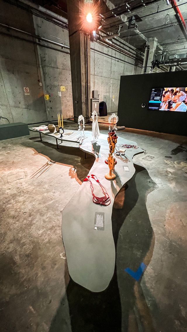 artifact display on curved table in concrete hall