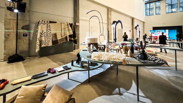 curved display tables with ceramics and textiles