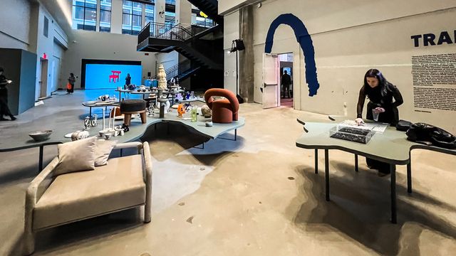 furniture exhibition with orange chair and blue screen