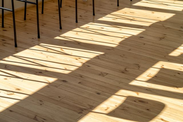 window shadow patterns on light wood plank floor