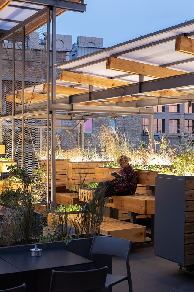 tiered wooden rooftop seating with planter lighting