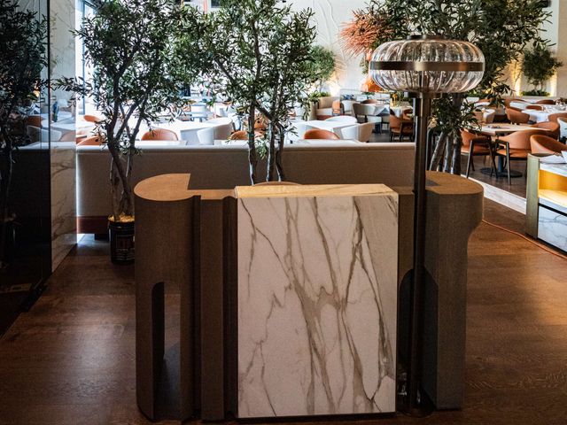 marble host stand with textured stone surround