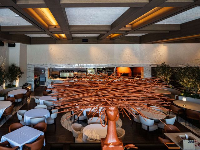 dining room with copper sculpture and open kitchen