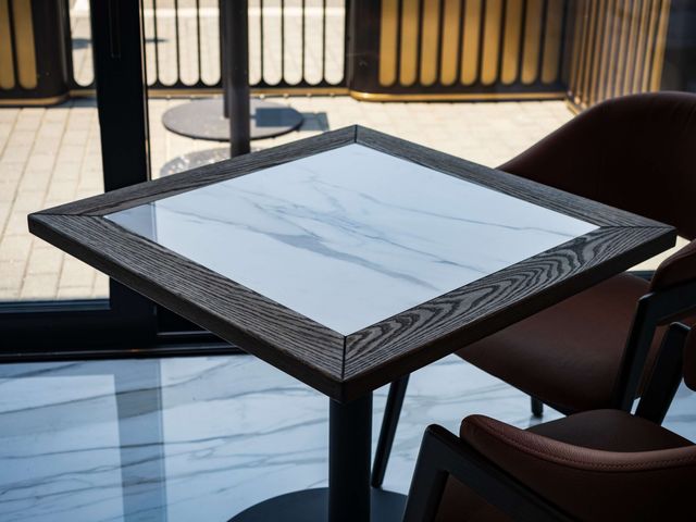 square marble cafe table with wood frame detail