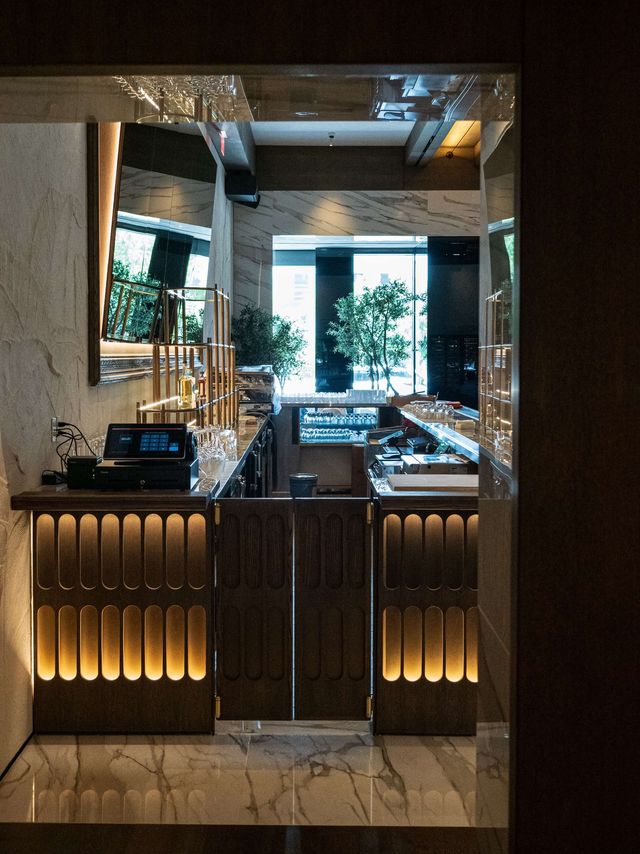 backlit wood service counter on marble floor