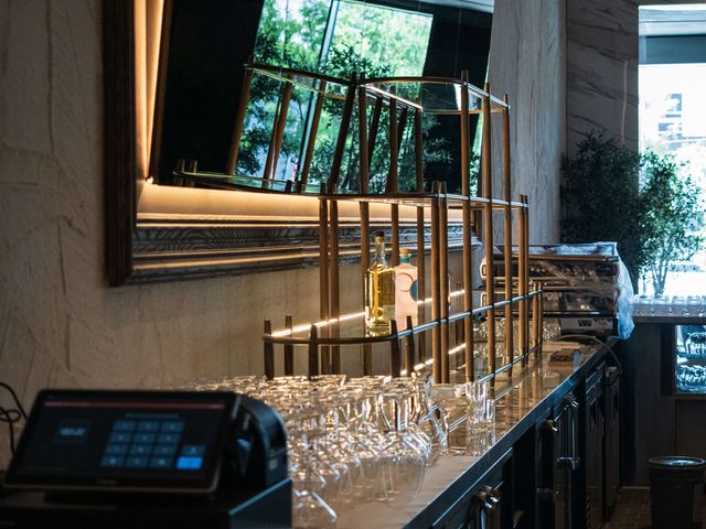 tiered glass bar shelving with wood-framed mirror