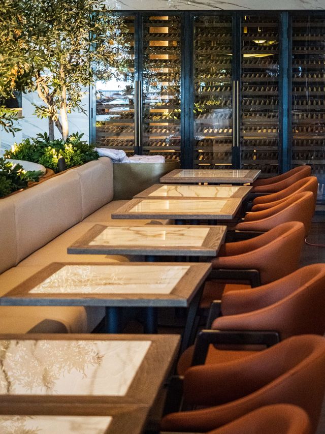 row of marble tables with terracotta chairs