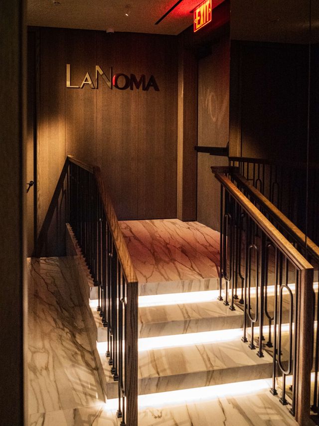 backlit marble stairs with lanoma wall sign