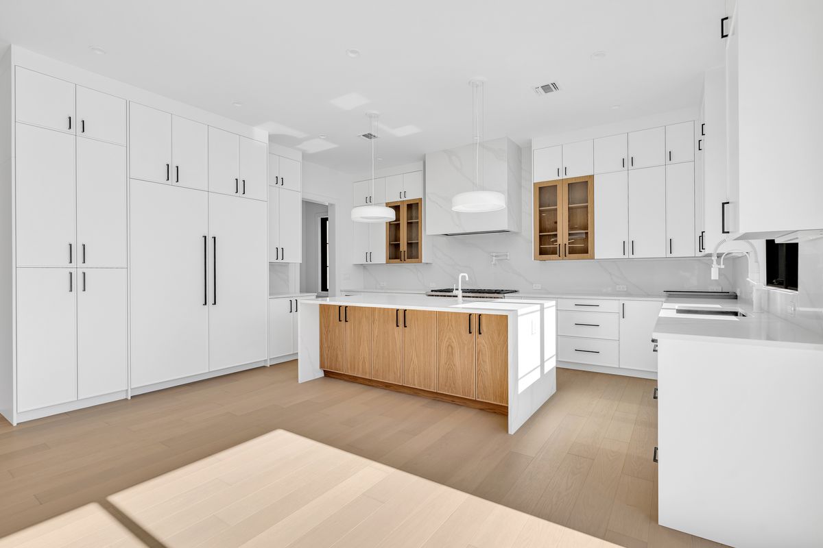 wide view of kitchen and waterfall island