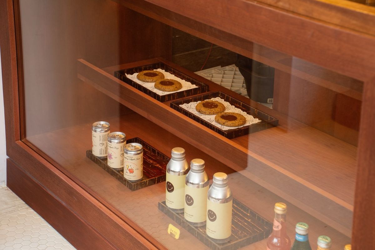 wooden display case with cookies and bottled drinks