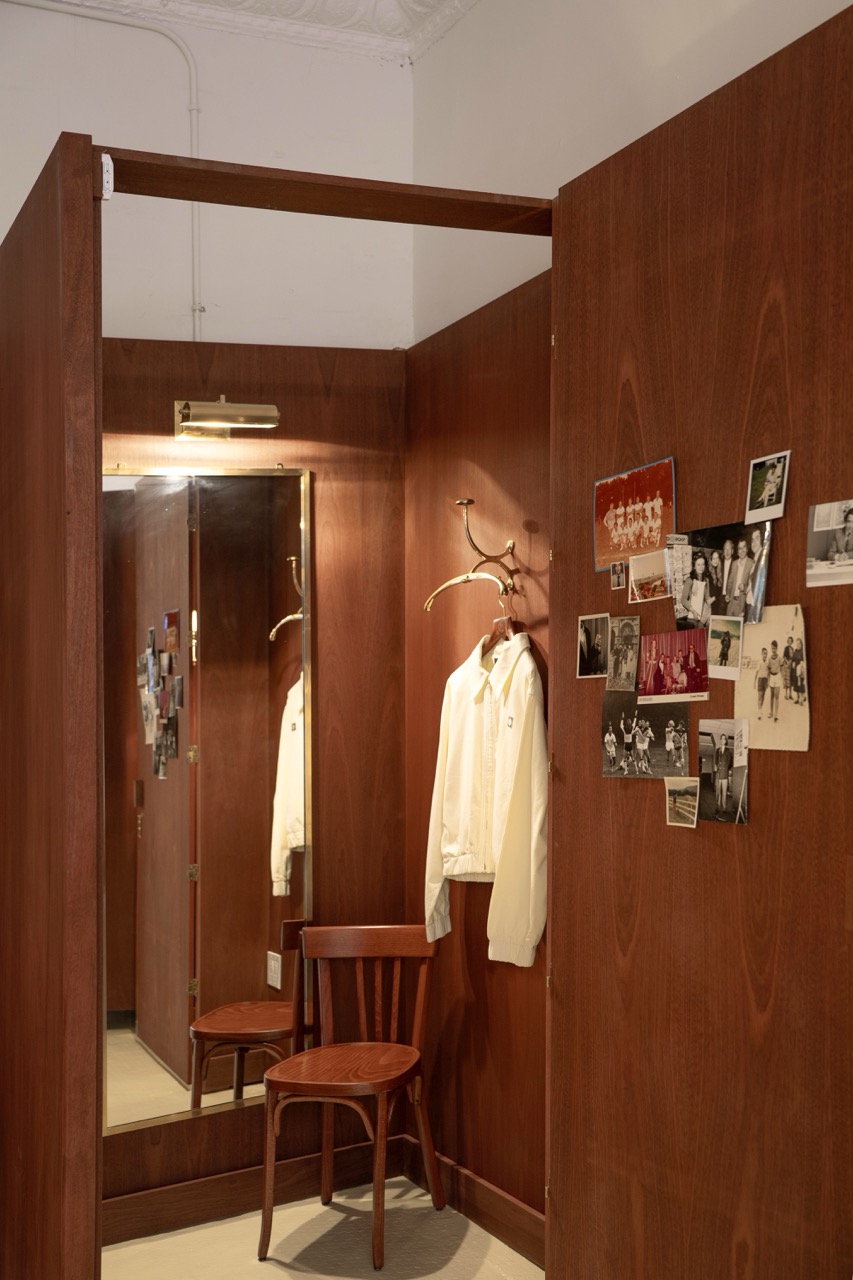 wood dressing nook with mirror and pinned photos