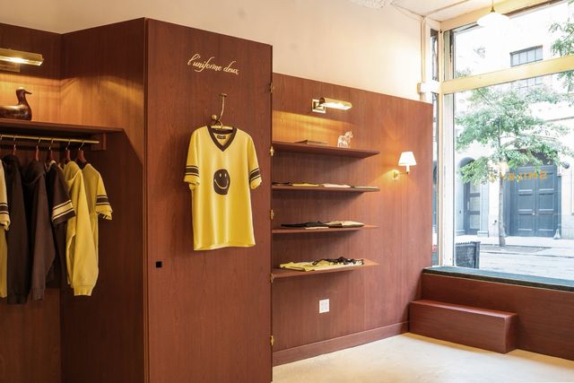merchandise wall with shelves and smiley tee display