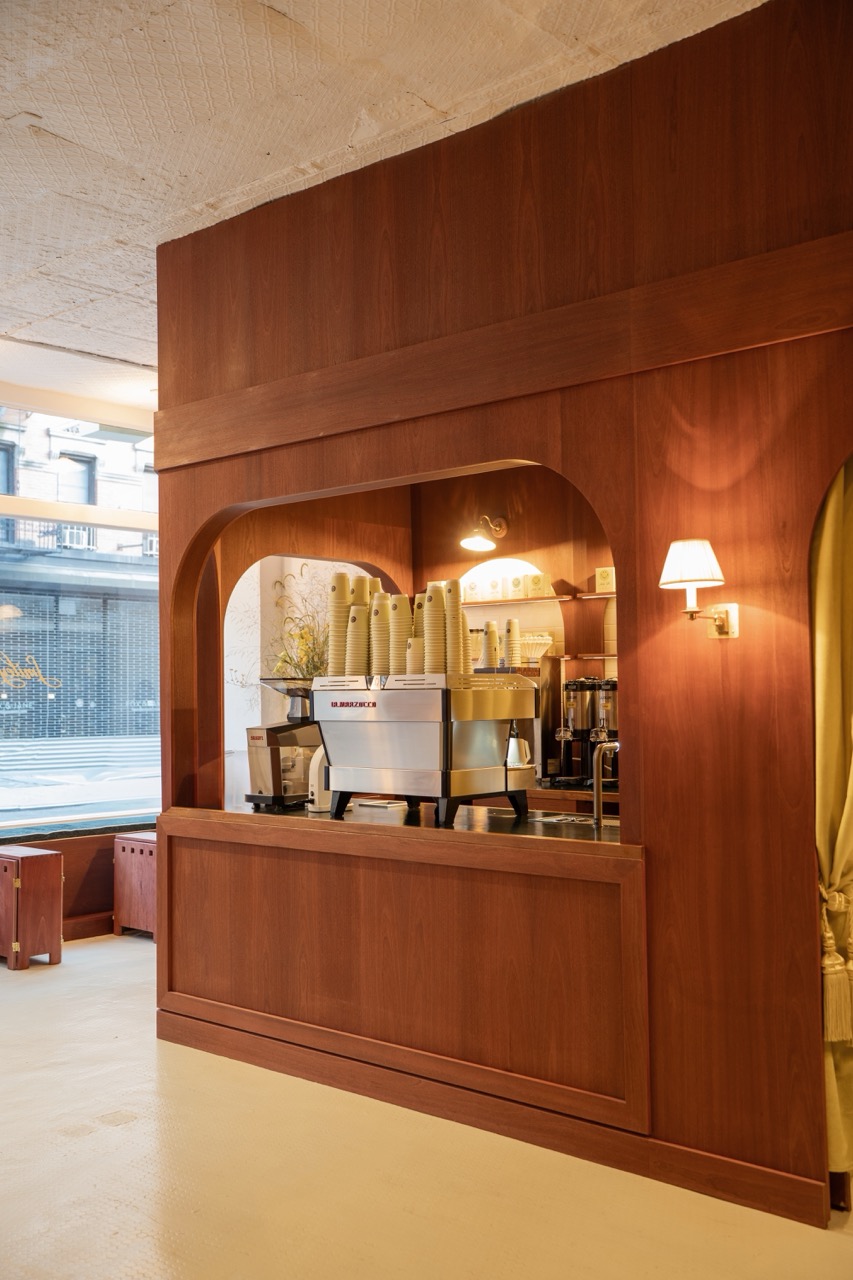 wood arched coffee bar with la marzocco machine