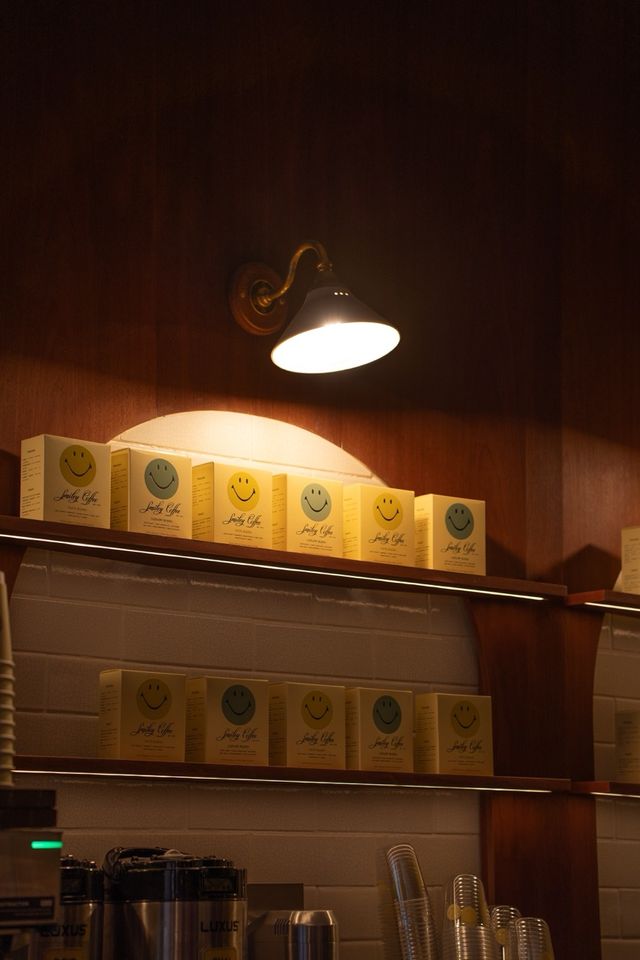 illuminated shelves with smiley coffee retail boxes